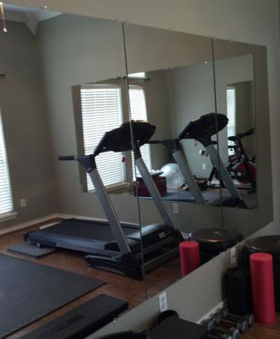 Row of mirrors from Home Depot used in a home gym
