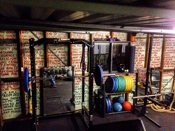 Leo's Powertec economy garage gym with words of inspiration overwhelming the senses